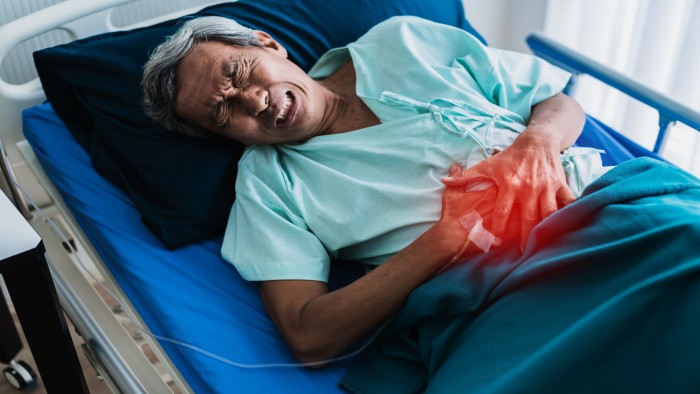 Elderly man suffering from severe abdominal pain due to kidney stones, seeking the best stone treatment in Vaishali
